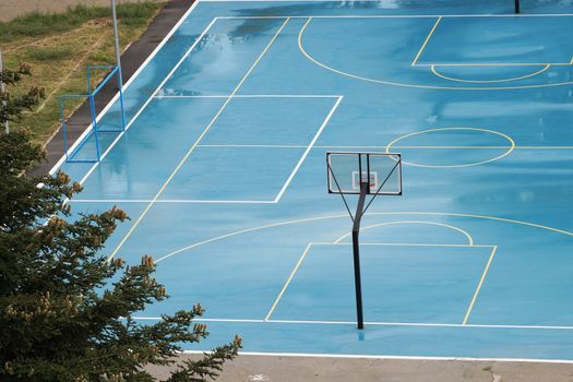 basketball court wet from the rain in a residential area, top view