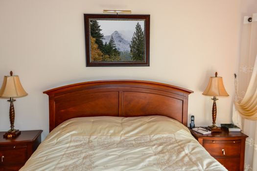 Beautiful bedroom with table lights on bedside tables beside the bed