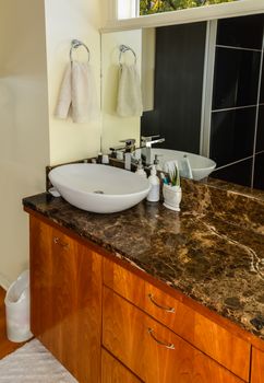 Hands wash basin at the mirror in a bathroom of luxury house