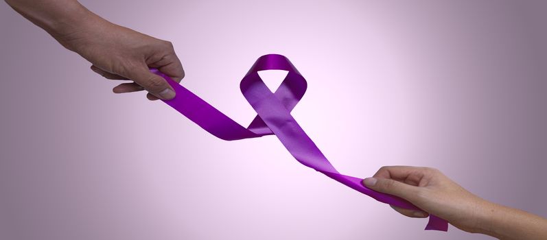 Female hands and men hand pulling pink ribbons expressing breast cancer awareness day concept isolated on pink background select focus ribbon.
