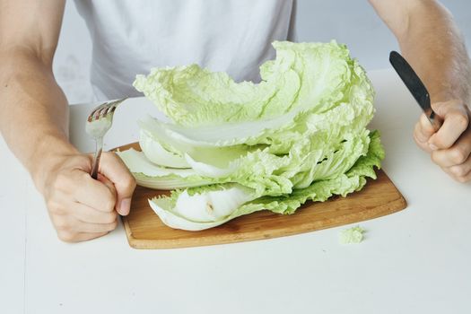 Cutting board cabbage leaves food intake vegetarianism. High quality photo