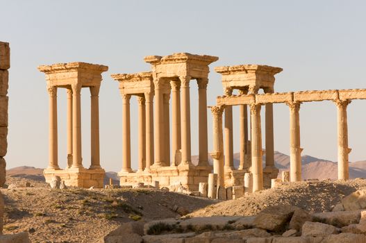 Palmyre Syria 2009 This ancient site has many Roman ruins, these standing columns shot in late afternoon sun are Tetrapylon, a set of four monuments with four columns each at the center of the colonnaded road leading to a Roman-era amphitheater . High quality photo