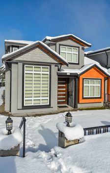 New family home for sale. New house in the suburbs on a sunny winter day