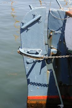 Rudder of a watercraft in the colors colours blue and red.