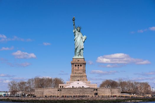 The Statue of Liberty under the blue sky background, Lower Manhattan, New York City, Architecture and building with tourist concept