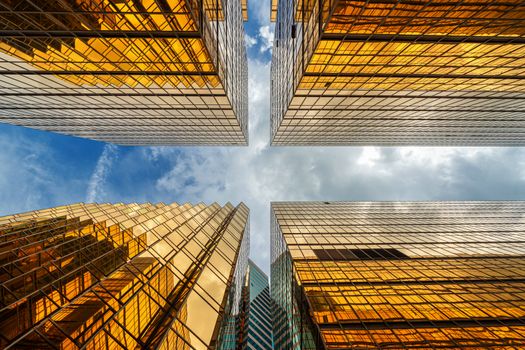 Uprisen angle of Hong Kong skyscraper with reflection of clouds among high building, Building glasses, business and financial, Architecture and industrial concept