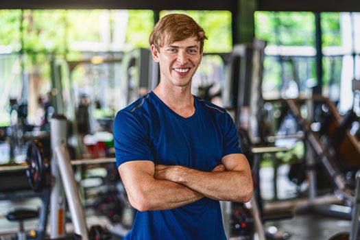 Portrait of Young man wearing sportswear in gym fitness sport complex, posture position, sport club community, sports and healthcare concept,