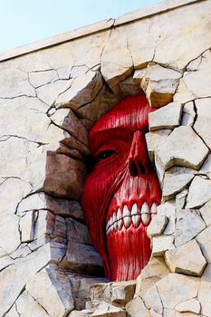 Osaka, Japan - Feb 6 2015 : Life size scale Statue of Wall giant from Attack on Titan (Shingeki no Kyojin) at Universal Studios Japan.