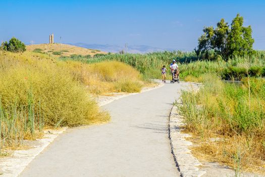 Nir David, Israel - August 23, 2020: View of a footpath, with visitors, in the Spring Valley Park (Park Hamaayanot), Northern Israel