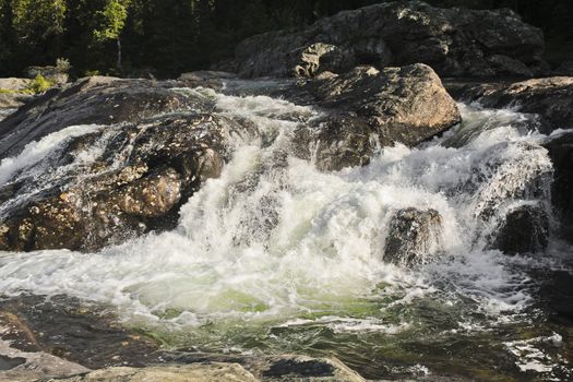 Fast flowing river water of the waterfall Rjukandefossen in Hemsedal, Buskerud, Norway.