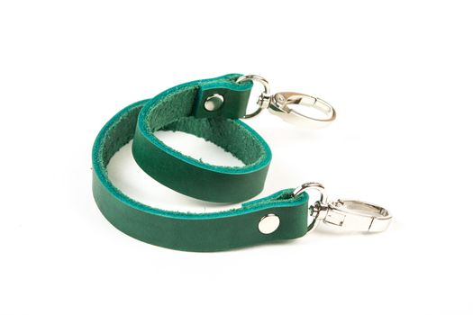 green leather belt with carbine and metal accessories isolated on white background. use for bags and suitcases