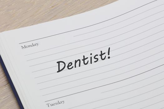 A Dentist appointment diary reminder open on desk