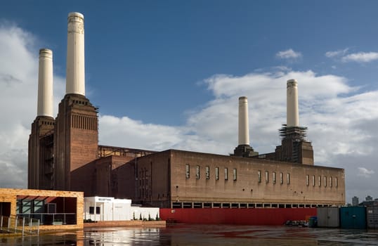 London, United Kingdom - October 01, 2006: Empty reception and entrance of decommissioned (in 1983) coal Battersea power station with one of iconic four white chimneys being fixed on a sunny day.