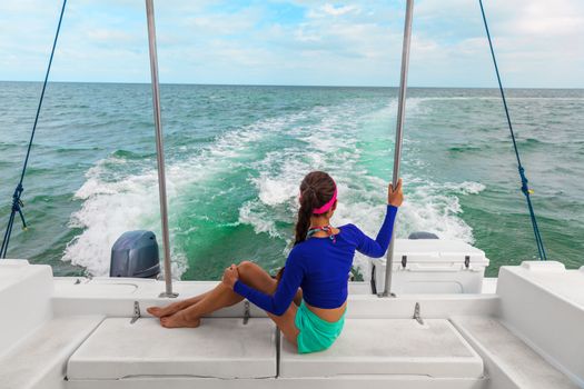 Travel boat excursion tour woman tourist relaxing on deck of motorboat catamaran, Florida, USA summer vacation.