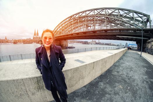 Yound beautiful woman and view of river with beautiful Cologne Cathedral in Germany
