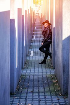 BERLIN, GERMANY - MARCH 26, 2017: Beautiful Young Asia Woman Tourist Walking at Holocaust Memorial to the Murdered Jews of Europe  in daylight at 26 March 2017, Berlin, Germany