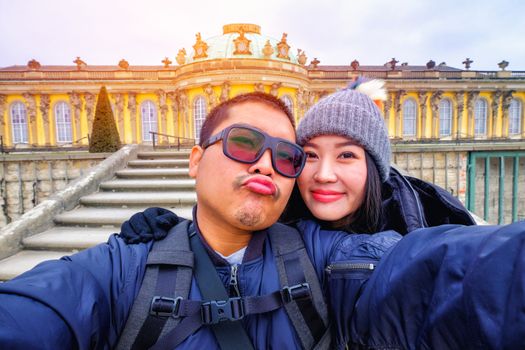 Young Couple Tourists selfie with smartphone at Sans Souci palace in Potsdam, Berlin, Germany