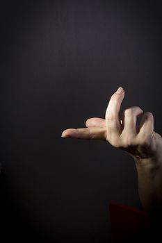 Female hand with protruding forefinger on black background