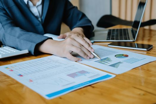 Business man investment consultant analyzing company annual financial report balance sheet statement working with documents graphs. Concept picture of business, market, office, tax