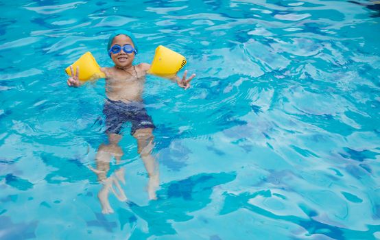 Boy practicing swimming in the pool