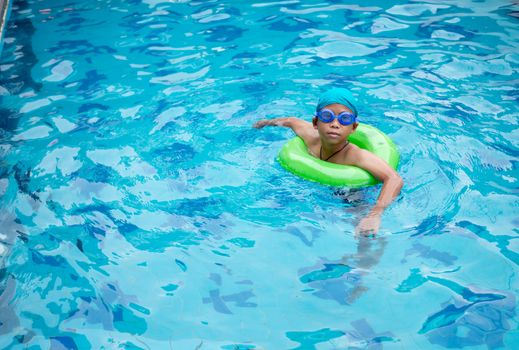 Boy practicing swimming in the pool