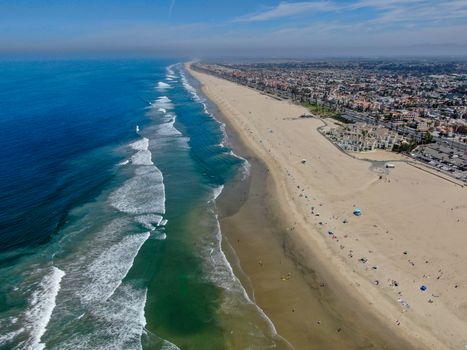 Aerial view of Huntington Beach and coastline during hot blue sunny summer day, Southeast of Los Angeles. California. destination for holiday and surfer