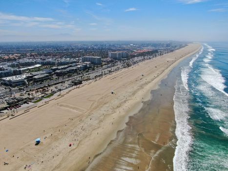Aerial view of Huntington Beach and coastline during hot blue sunny summer day, Southeast of Los Angeles. California. destination for holiday and surfer