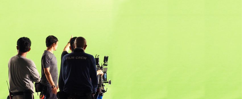 Camera and green screen studio in panorama view and man working or shooting or recording or filming.