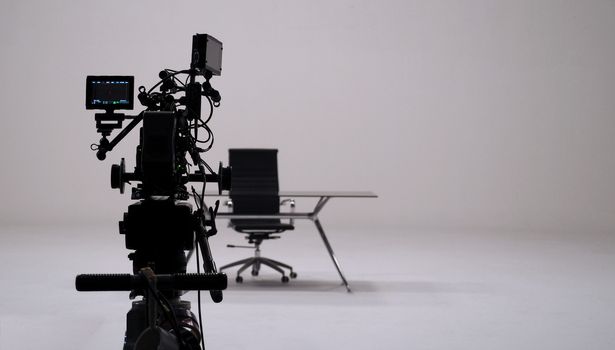 TV commercial recording and movie camera set and camera man in big studio.