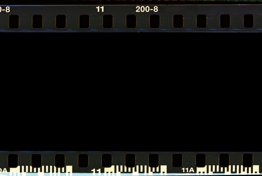 Real film border strip scan and old texture frame and isolated black space.