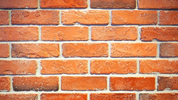 Red brick wall and old dirty rough surface texture close-up.