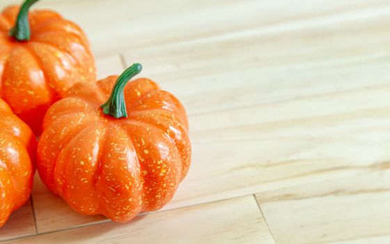 The pumpkin toy on wood table for food content.