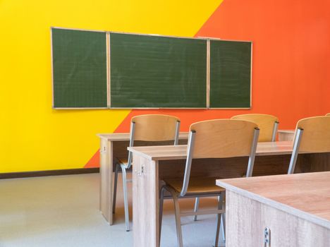 An empty school classroom with a blackboard. Interior of a school classroom