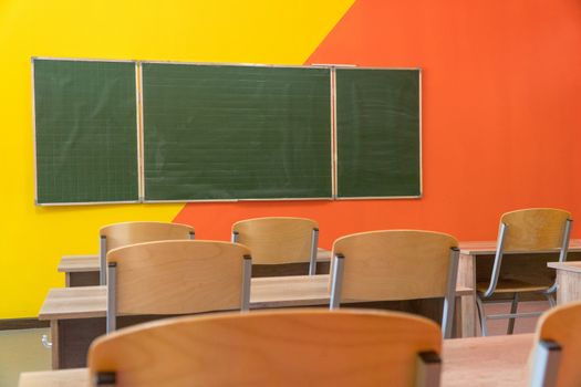 An empty school classroom with a blackboard. Interior of a school classroom