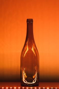 abstract empty wine bottle with orange led illumination