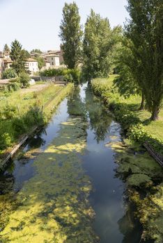 Small river of the pass outside the town of Bevagna on a sunny day