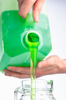 liquid soap in plastic bottle, pouring by hands