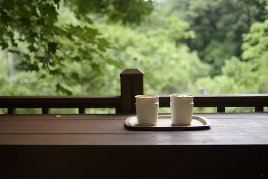 Cup of coffee with latte art on wooden background