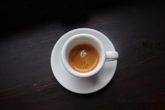 Cup of coffee with latte art on wooden background