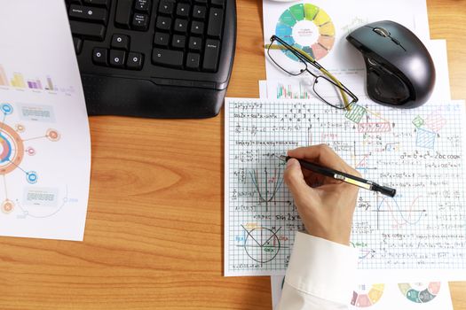 Close up hand of business women writing on paper in office. Hand of business people use pencil writing work plan on paper on office desk Business financial business at home and office concept.
