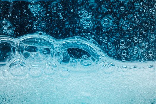 abstract liquid soap bubbles blue background