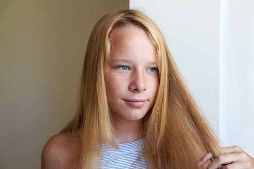portrait of smiling girl with long blond hair, copy space