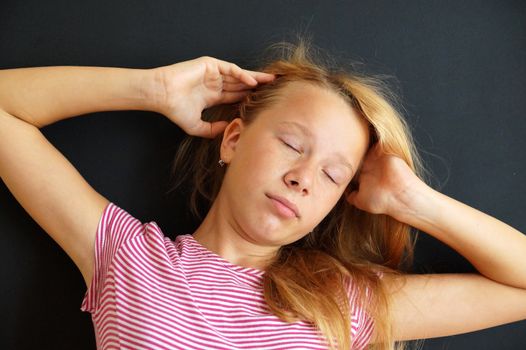 teenage girl just woke up, portrait on black background.