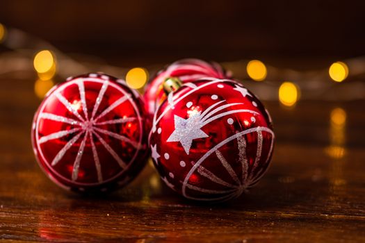 Red Christmas balls isolated on blurred and shiny background of lights. Christmas baubles isolated.