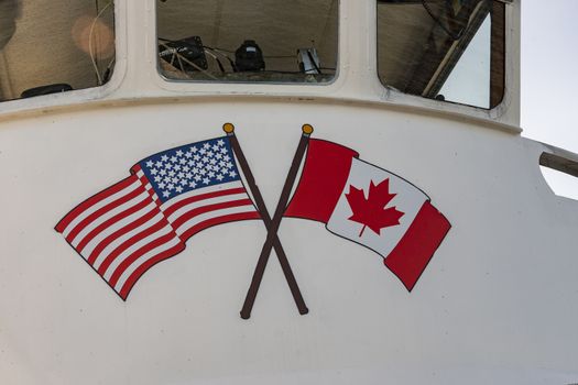 Fragment of a cruise ship cabin with American and Canadian flags