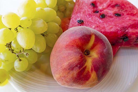 peaches, watermelons, and grape fruits on plate