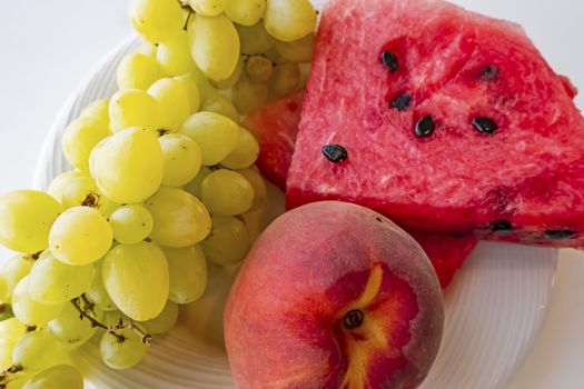 peaches, watermelons, and grape fruits on plate