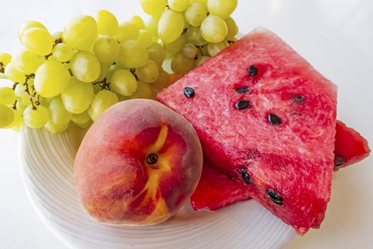 peaches, watermelons, and grape fruits on plate