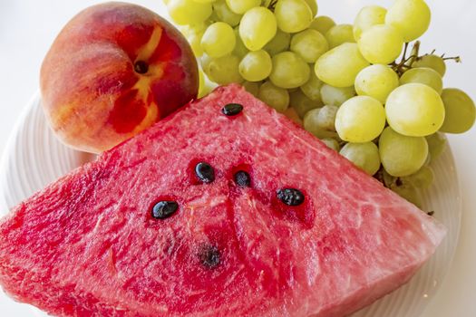 peaches, watermelons, and grape fruits on plate