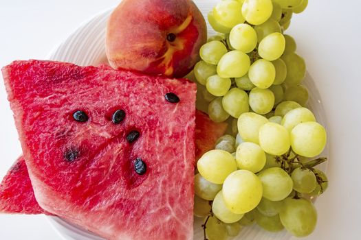 peaches, watermelons, and grape fruits on plate